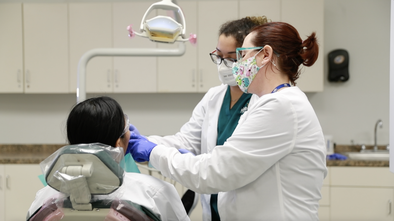 Dentist examining patient in clinic