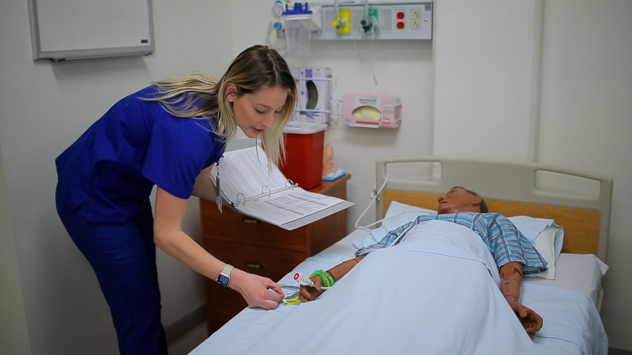 Nurse attending to patient in hospital room