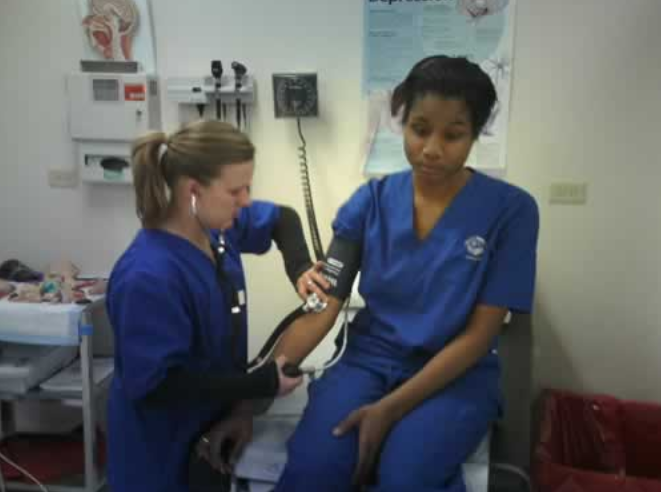 Medical students practicing blood pressure check