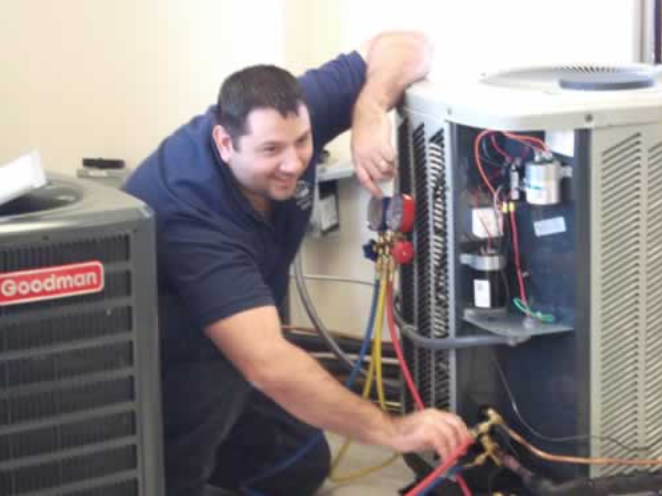 Technician servicing Goodman HVAC system